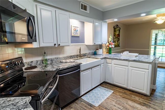 View of kitchen toward dining area. Please note farmhouse kitchen sink and counter serving opportunity for the dining area. | Image 35