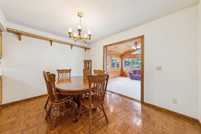 Main level dining room with gleaming mosaic wood floors | Image 8