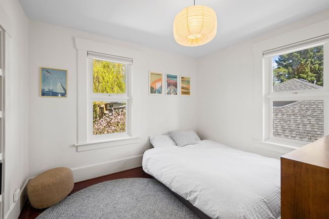 Bedroom with baseboards, wood finished floors, and multiple windows | Image 27