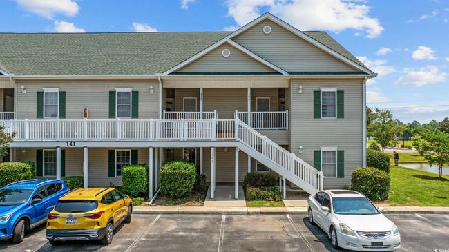 View of building exterior featuring uncovered parking and stairway | Image 35