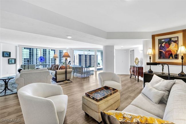 Living area featuring baseboards, a healthy amount of sunlight, and wood finished floors | Image 10