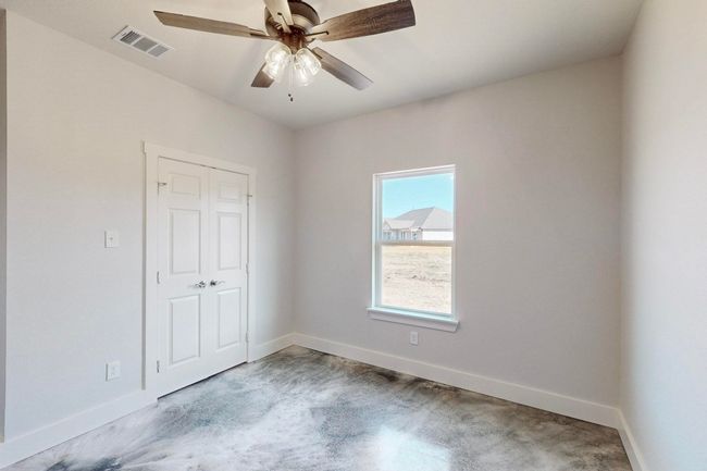 Unfurnished bedroom featuring visible vents, baseboards, a closet, and ceiling fan | Image 26
