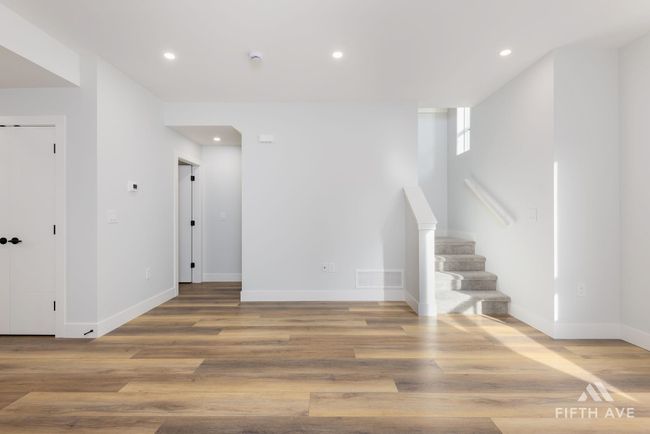 Unfurnished living room featuring stairs, recessed lighting, and wood finished floors | Image 10