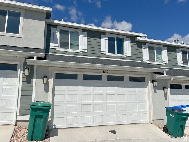 Garage featuring concrete driveway | Image 9