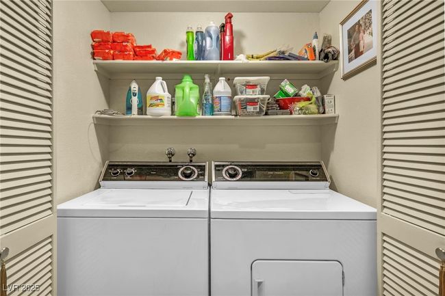 Washroom featuring washing machine and dryer and laundry area | Image 37