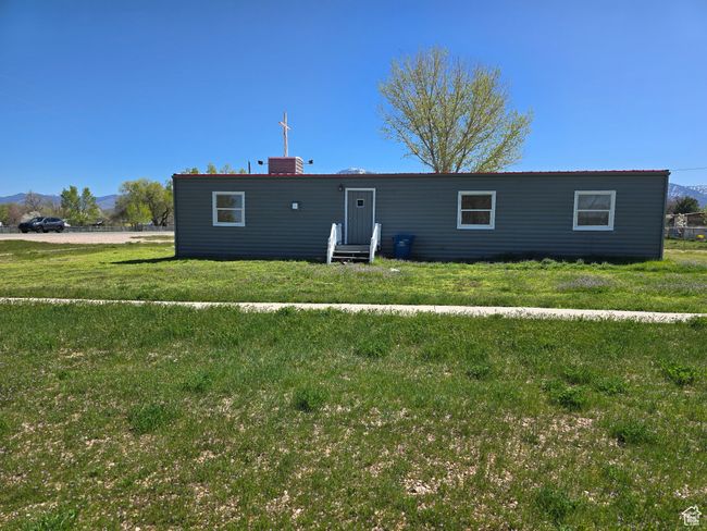 View of front of house featuring a front lawn, entry steps, a chimney, and a mountain view | Image 19