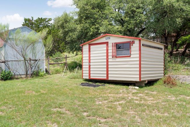 Large metal storage shed keeps tools and toys tucked away without sacrificing space. | Image 29