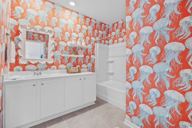 Bathroom with wallpapered walls, vanity, shower / bath combination, and tile patterned floors | Image 20
