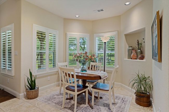 Dining space with healthy amount of natural light, tile patterned floors, baseboards, and recessed lighting | Image 10