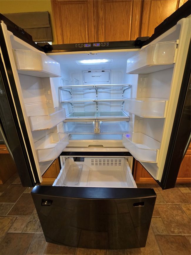 Kitchen view of fridge, brown cabinets, and open​​‌​​​​‌​​‌‌​‌‌​​​‌‌​​‌‌​‌​​​​​‌ shelves | Image 25