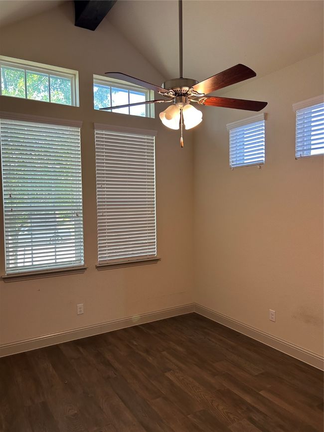 Spare room with ceiling fan, dark wood-type flooring, and baseboards | Image 23