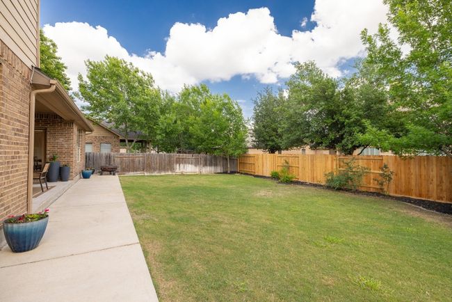 View of yard with a fenced backyard and a patio area | Image 39