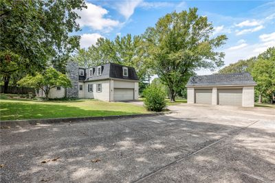 View of the driveway extension back towards the 4-car garages and backyard access. | Image 2