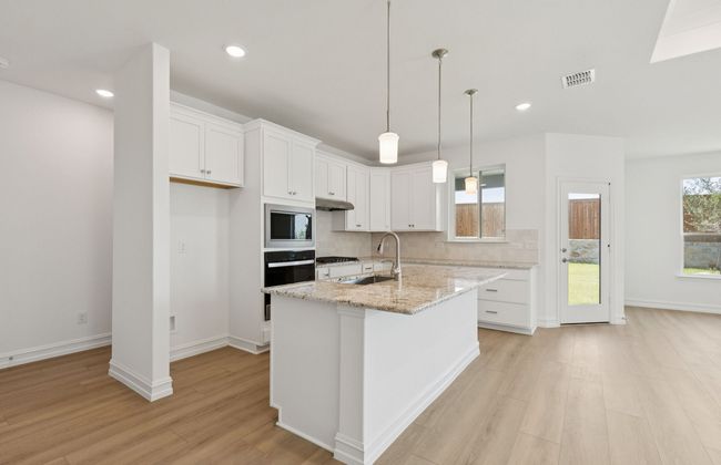 Bright kitchen with an expansive center island perfect for gatherings *Real home pictured | Image 7