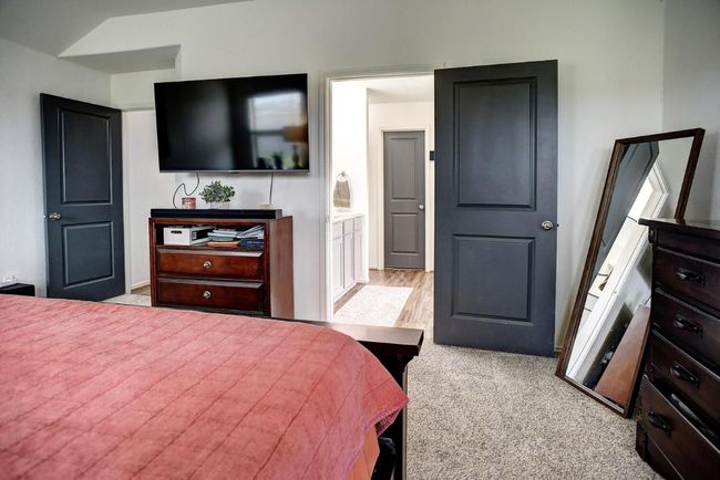 Bedroom featuring vaulted ceiling, carpet, and ensuite bath | Image 18