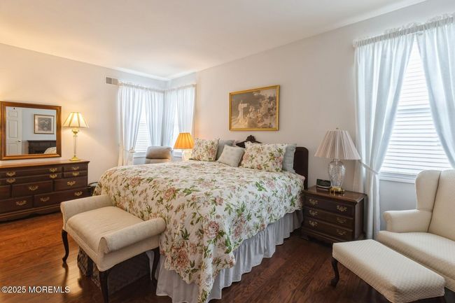 Lovely primary bedroom with hardwood floors. | Image 15