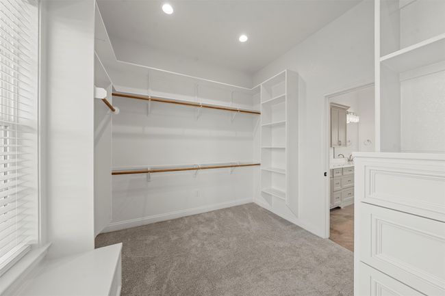 Spacious closet with carpet floors and a sink | Image 16