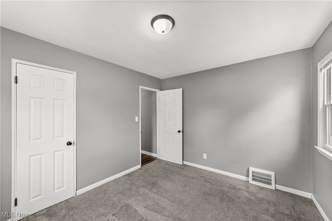 Bedroom featuring carpet, visible vents, and baseboards | Image 20