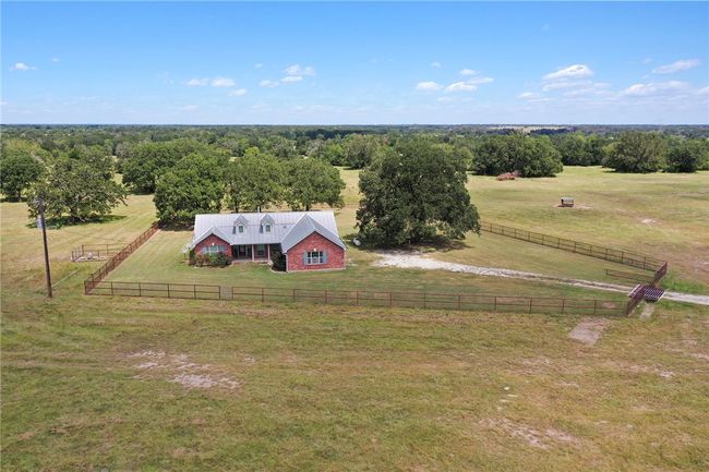Aerial view of sparsely populated area featuring agricultural land | Image 4