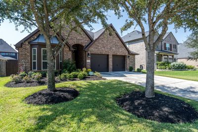 There is pride and ownership that comes with this home! It is so well maintained, and just look at this manicured yard with lush flowerbeds and mature trees. | Image 3