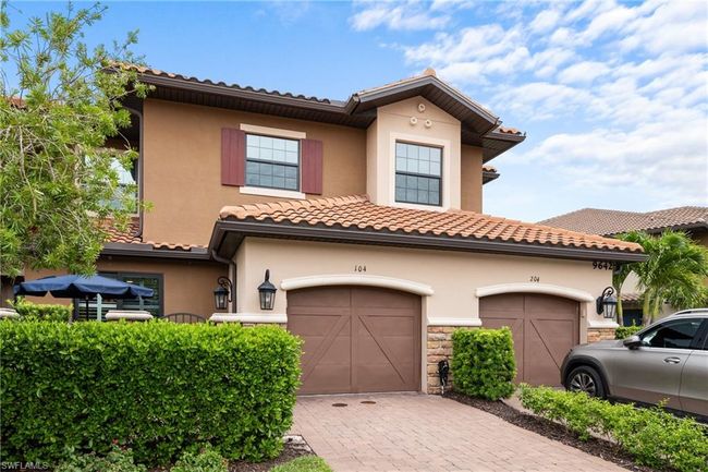 View of front of home featuring stucco siding, stone siding, decorative driveway, and a tiled roof | Image 30