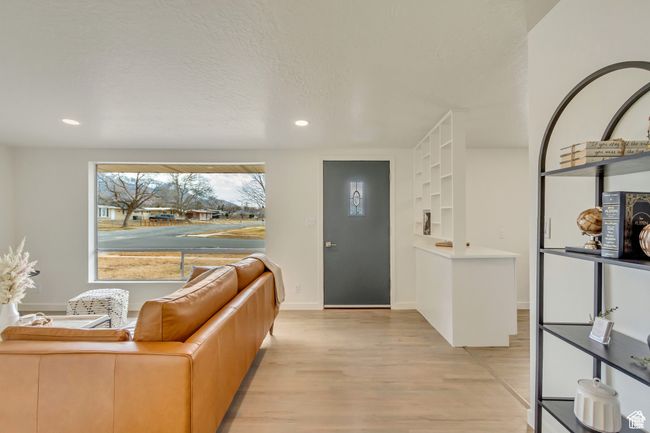 Entrance foyer featuring light wood-type flooring, baseboards, recessed lighting, and a textured ceiling | Image 6