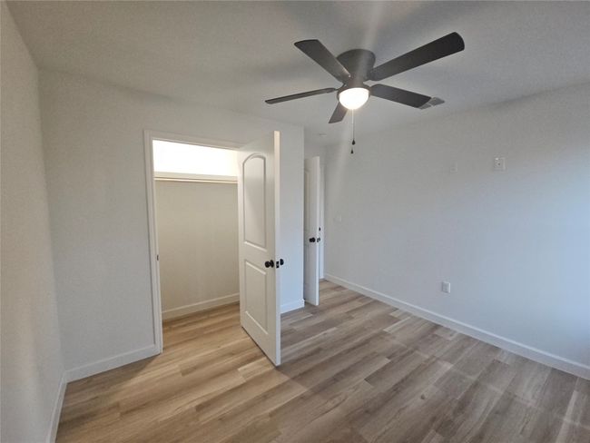 Unfurnished room with visible vents, baseboards, and light wood finished floors | Image 14