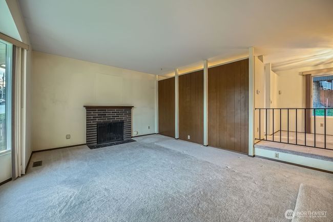 Bring your vision and paint brush to make this space work for you!! Behind paneled wall is the kitchen. | Image 7