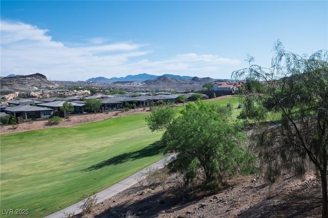 View of mountain backdrop featuring nearby suburban area and a golf course | Image 24