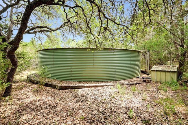 50, 000 Gallons of Rain Water Storage. The pump house is to the right of the tank. Not in the direct line of site from inside the home. | Image 29