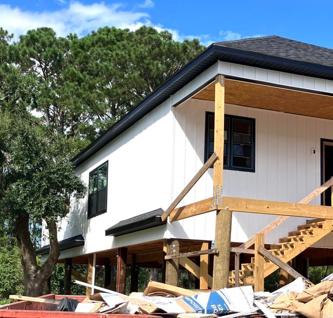 View of home's exterior with a shingled roof and stairs | Image 5