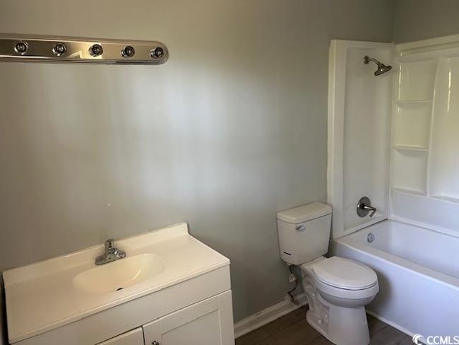 Bathroom featuring toilet, shower / bathtub combination, vanity, and baseboards | Image 21