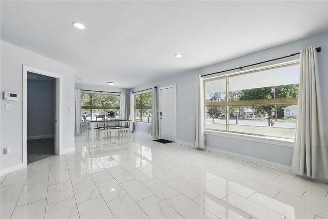Spare room featuring baseboards, recessed lighting, and light marble finish flooring | Image 8