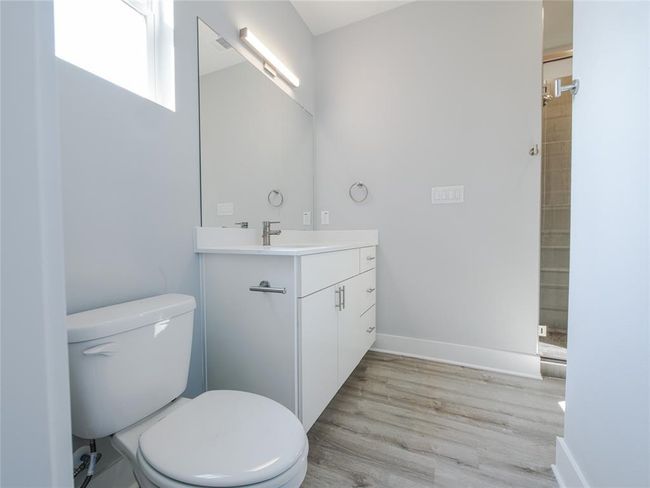 Bathroom with vanity, wood finished floors, and a shower | Image 30
