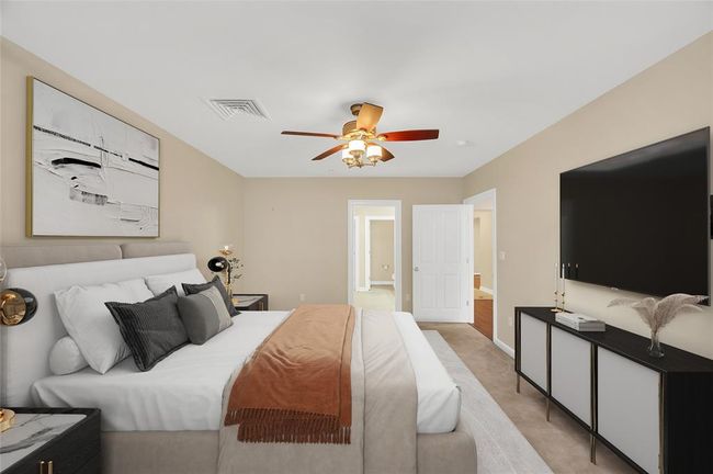 Another view of Primary Bedroom. Ceiling fan above with wall mounted controls. PHOTO VIRTUALLY STAGED. | Image 22