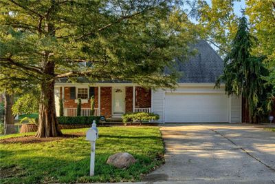 View of front of property with a garage, a porch, and a front yard | Image 2