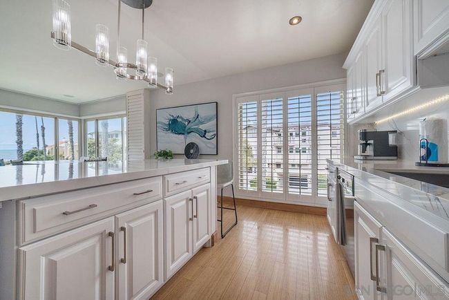 The kitchen looking from the entry way toward street view. | Image 10