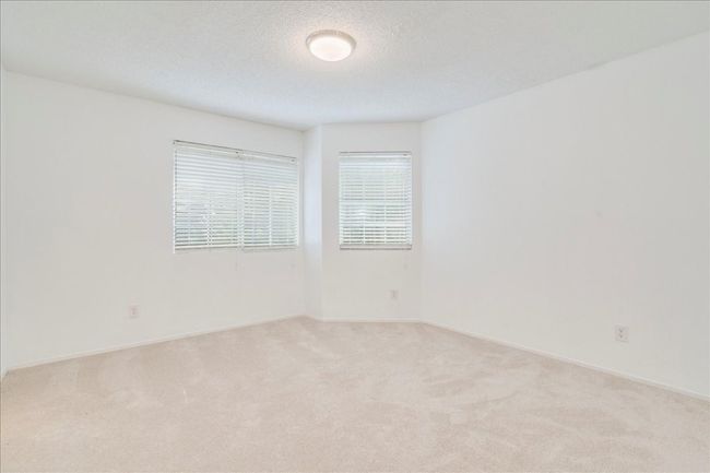 Unfurnished room with light carpet, baseboards, and a textured ceiling | Image 25