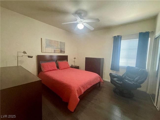 Bedroom with ceiling fan, wood finished floors, and baseboards | Image 38