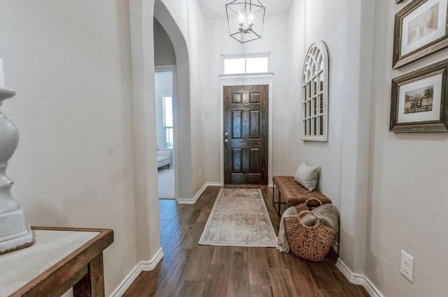 Foyer with arched walkways, dark wood-type flooring, plenty of natural light, and baseboards | Image 7