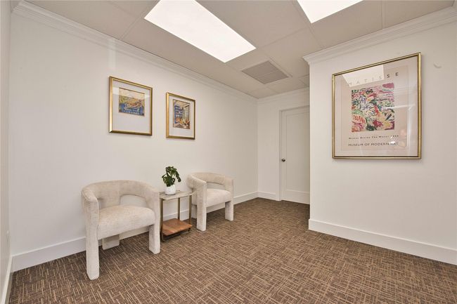 Living area featuring crown molding, dark carpet, and baseboards | Image 4