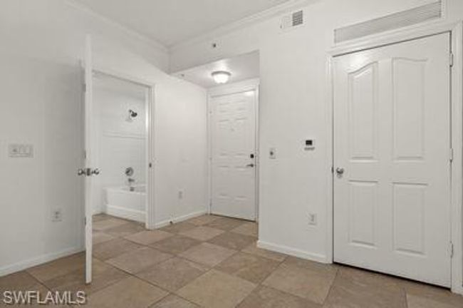 Entrance foyer with crown molding, visible vents, and baseboards | Image 4
