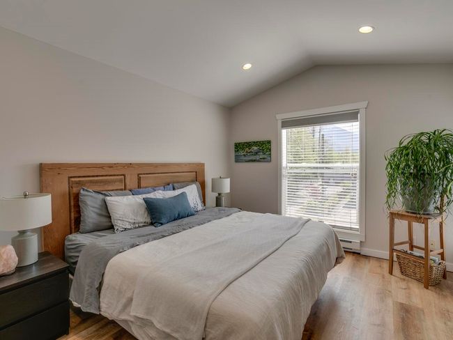 Bedroom featuring recessed lighting, vaulted ceiling, a baseboard heating unit, light wood-type flooring, and baseboards | Image 20