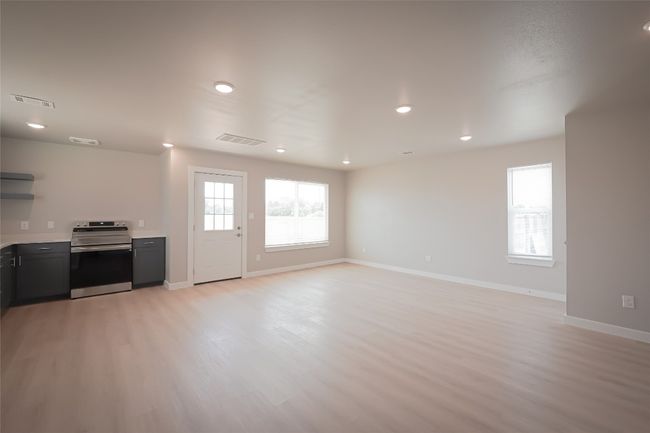 Unfurnished living room with light wood-type flooring and recessed lighting | Image 9