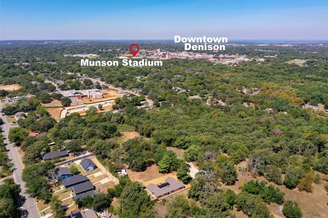 The house is in the center foreground of the picture with the city all around it. | Image 6