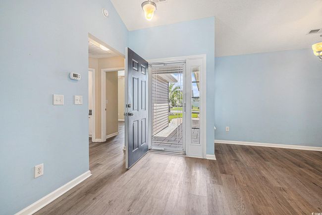 Entrance foyer featuring wood finished floors and lofted ceiling | Image 6