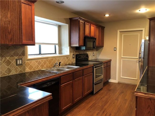 Kitchen has nice window for natural light. Good counter space. | Image 5