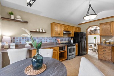 Another view of the kitchen from the adjacent informal dining room. | Image 3