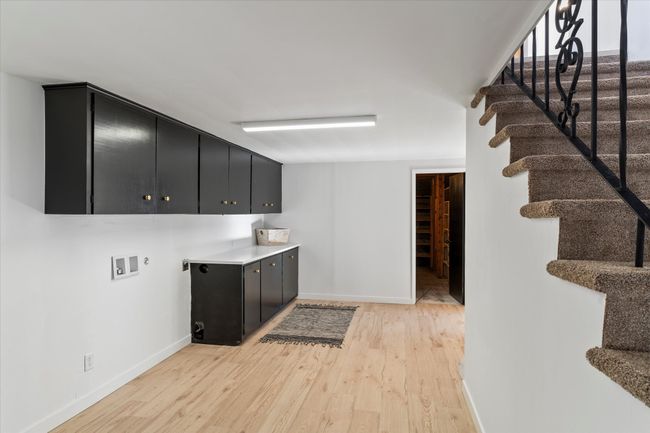 Laundry area with hookup for a washing machine, cabinets, and light hardwood / wood-style floors | Image 31