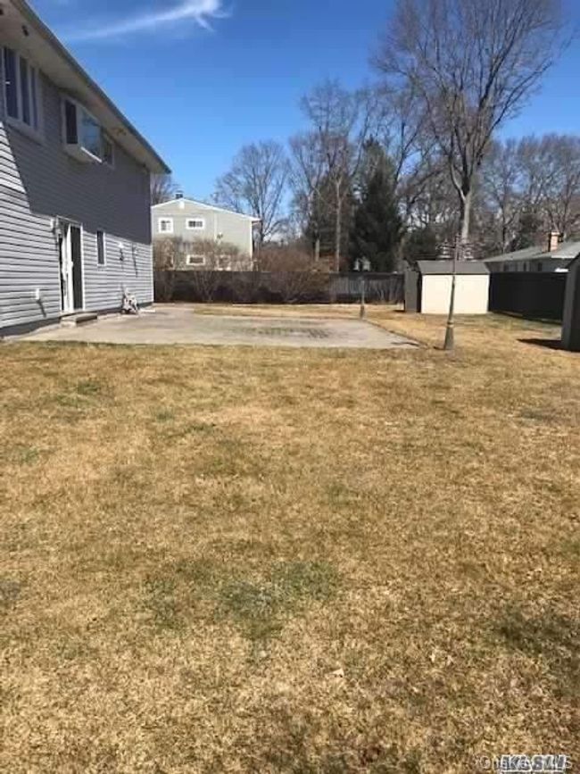 View of yard featuring a storage shed, a patio area | Image 17